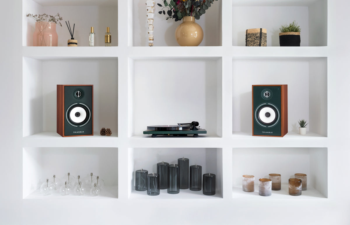 Triangle speakers and a turntable in a large living room
